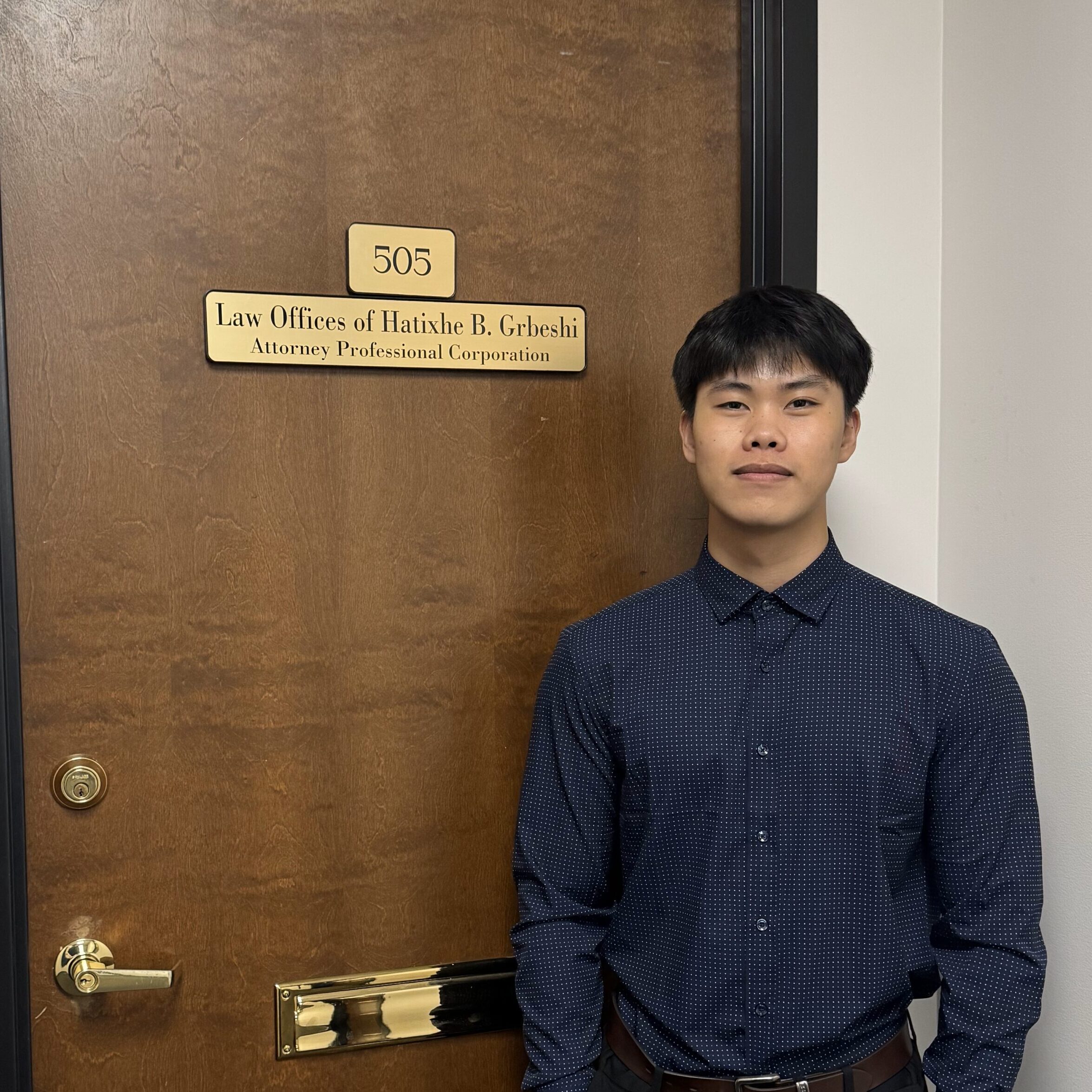 HUEU A man standing in front of a door.